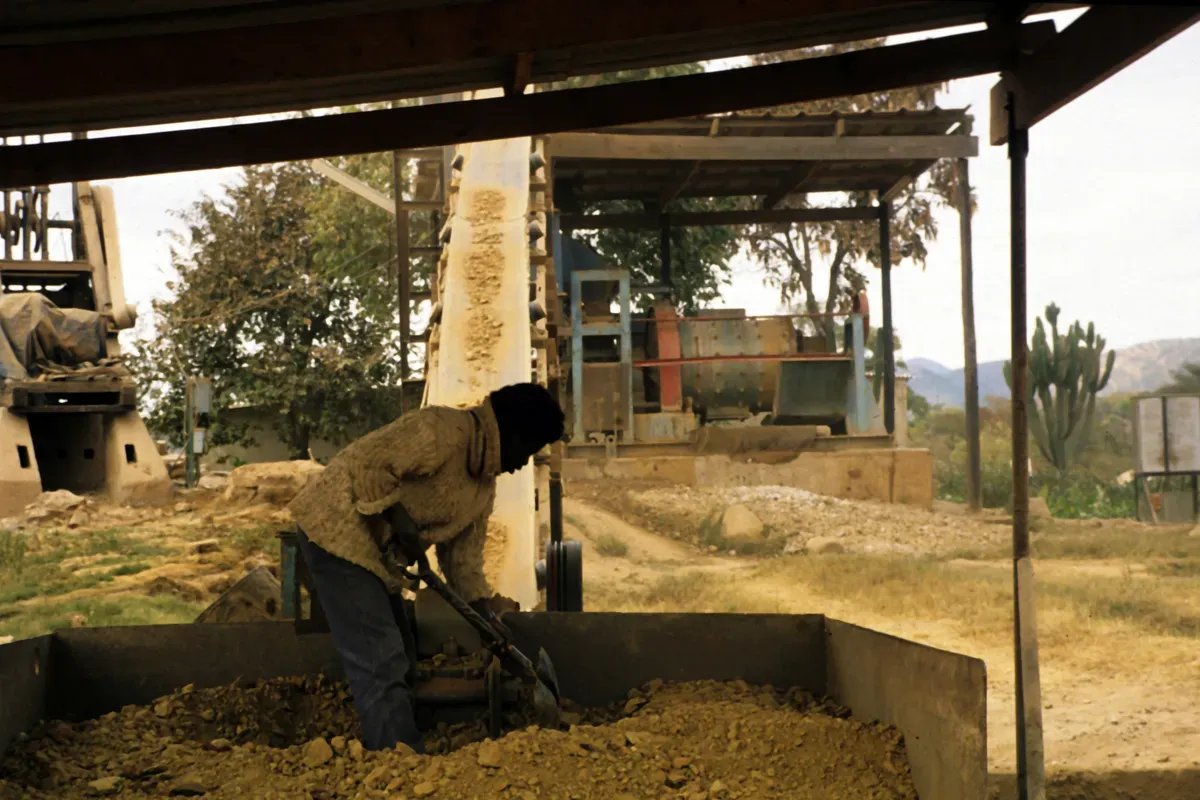 Gold ore processing site with crushing and grinding equipment
